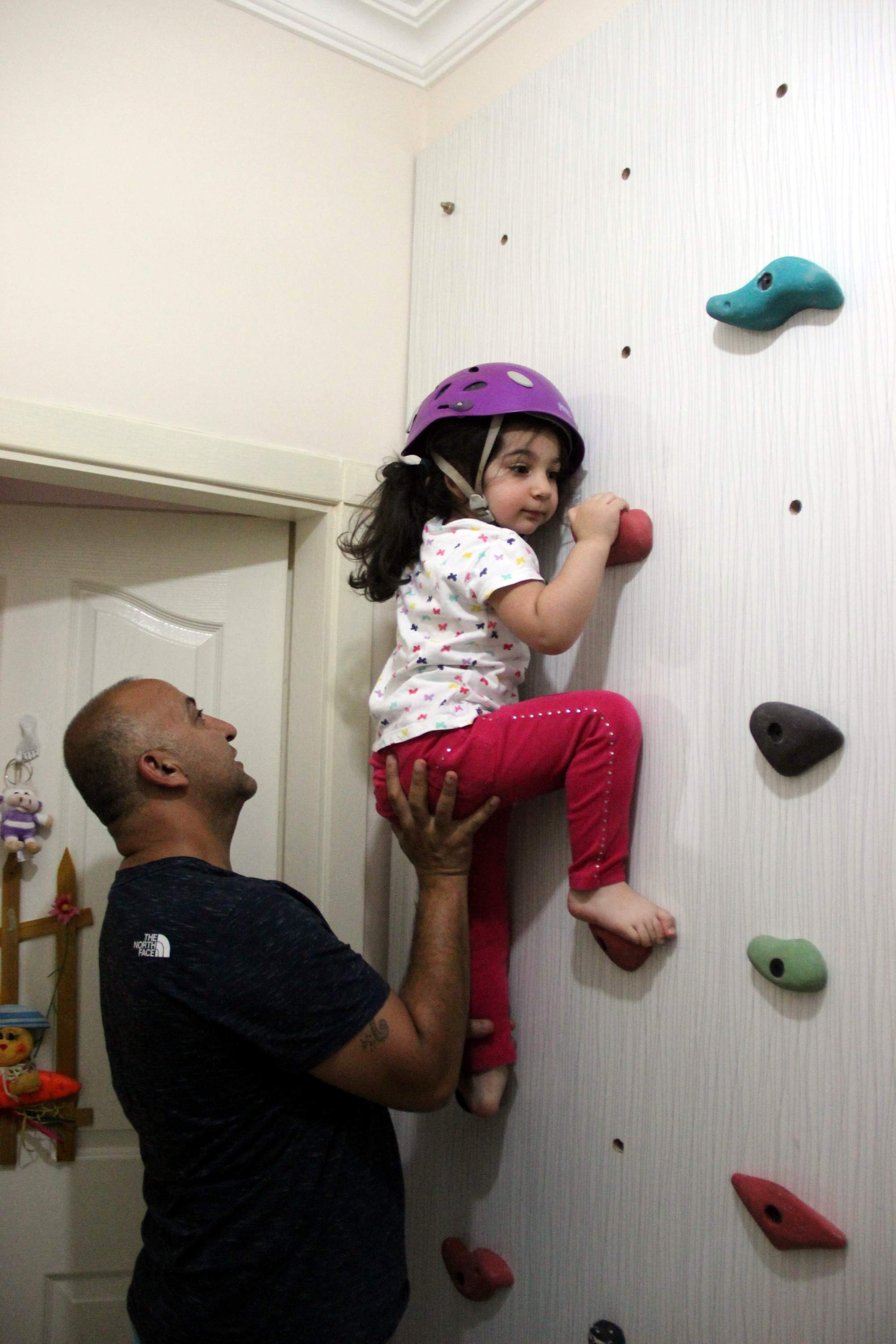Kızını dağcılık sporuna alıştırmak için evine tırmanma duvarı yaptı